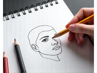 An artist's hand illustrating basic facial proportions and features using a pencil on paper, demonstrating fundamental drawing concepts.